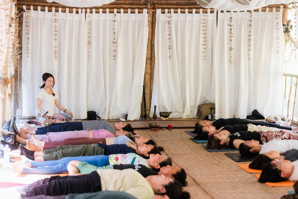ครูนั่งดูแลผู้เรียนที่นอนพักในท่าศพ